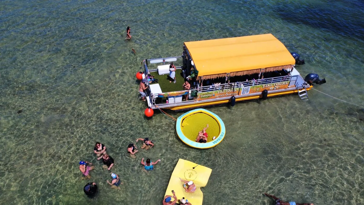 Aerial view of guests enjoying the sandbar with the Tiki Paradiso