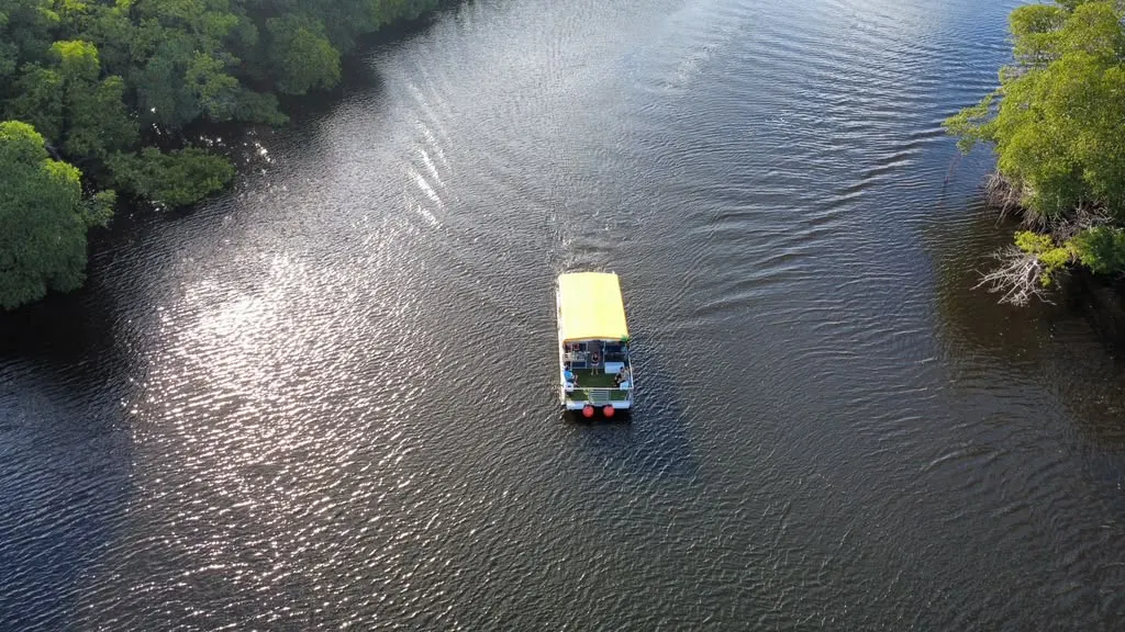 Aerial view of Tiki Paradiso cruising through Oleta River mangrove canal